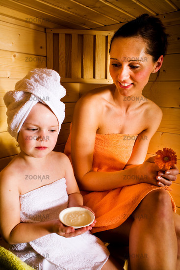 a mother and a little girl in the sauna